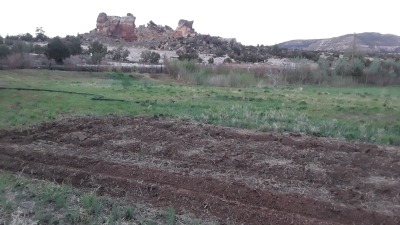 freshly tilled field in front of the castle rocks