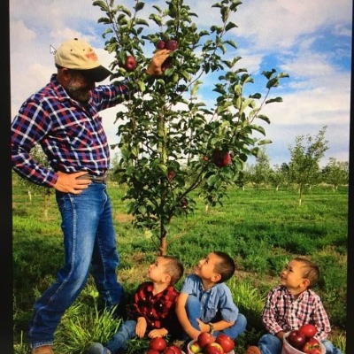 Orchardist with young pickers